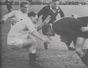 Colin Meads decides to barge through Judd rather than seek a way round him. English half-back, Simon Clarke, and All Black prop, Ian Clarke, close in.